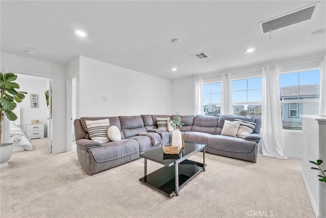 carpeted living area featuring visible vents, a wealth of natural light, and recessed lighting