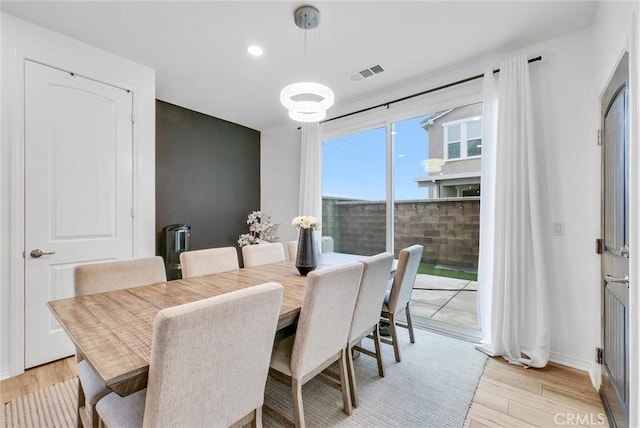 dining space with recessed lighting, light wood-style floors, visible vents, and baseboards