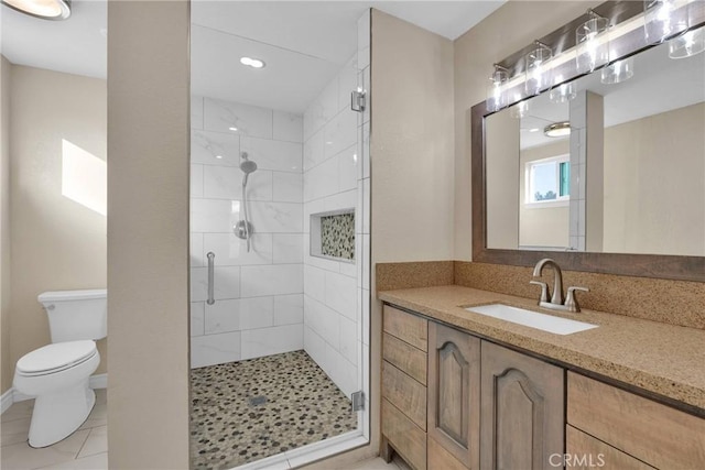 bathroom with vanity, tile patterned flooring, toilet, and walk in shower