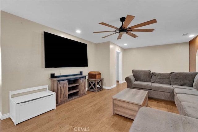 living room featuring ceiling fan and light wood-type flooring