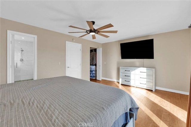 bedroom with wood-type flooring, ceiling fan, and ensuite bathroom