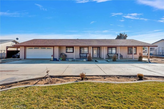 single story home featuring a garage, a front lawn, and a porch