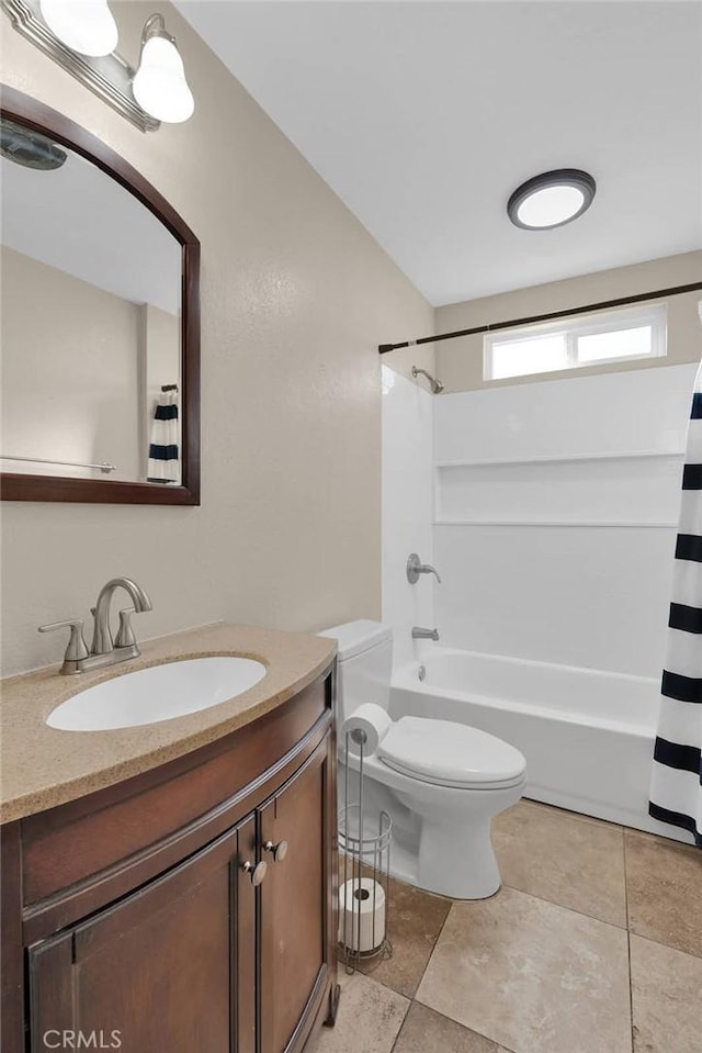 full bathroom featuring tile patterned floors, vanity, toilet, and shower / bath combo with shower curtain