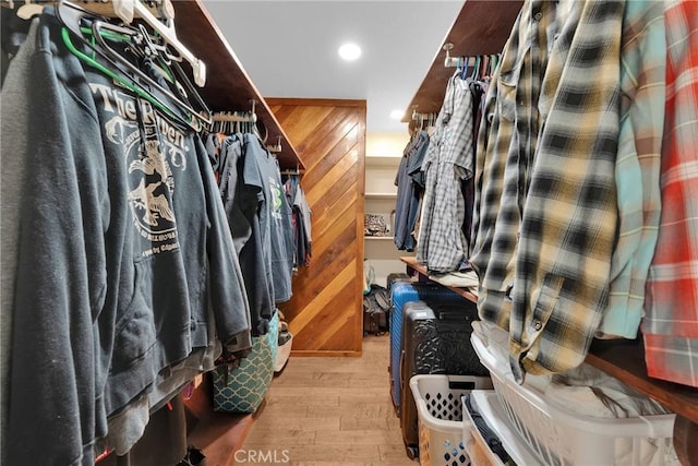 walk in closet with light wood-type flooring