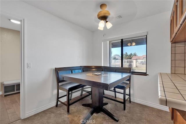 dining space featuring ceiling fan