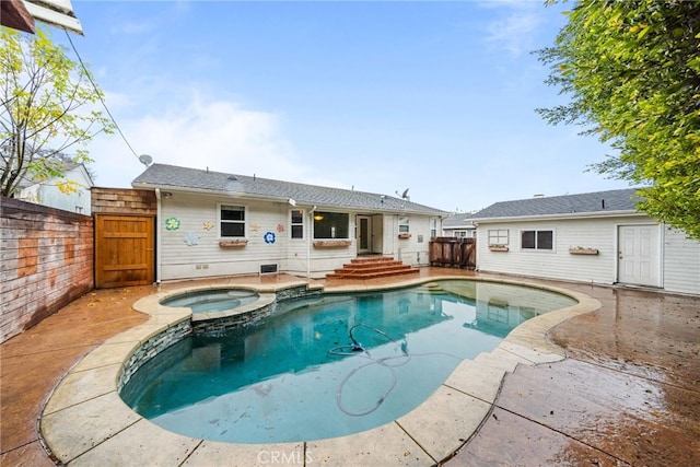 view of pool with a patio area and an in ground hot tub