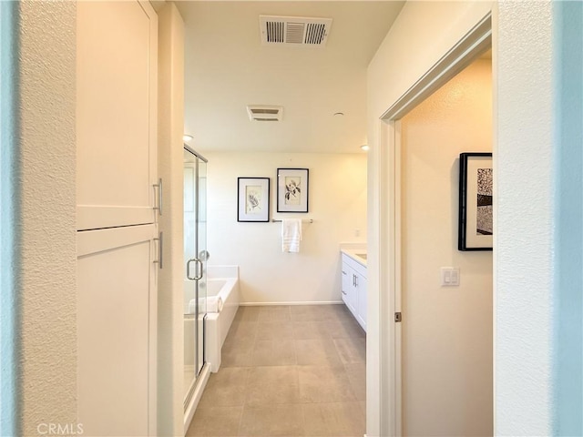 bathroom featuring vanity, tile patterned flooring, and separate shower and tub