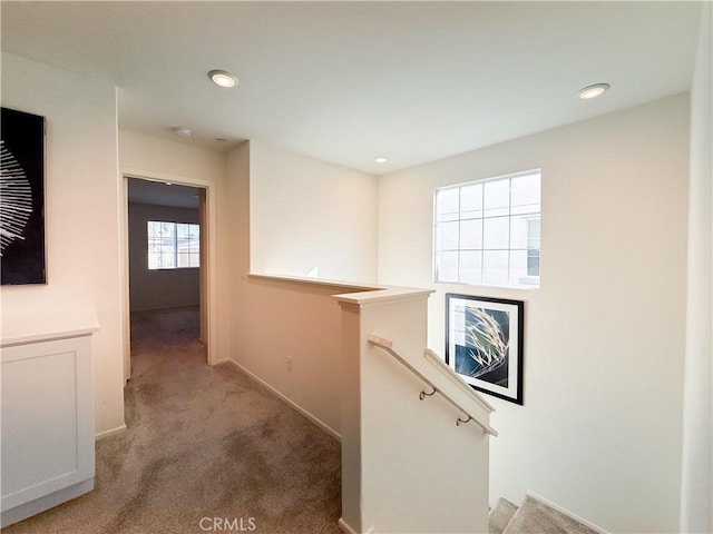 hallway with light colored carpet