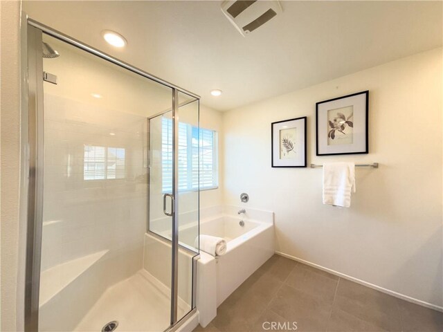 bathroom with tile patterned floors and independent shower and bath