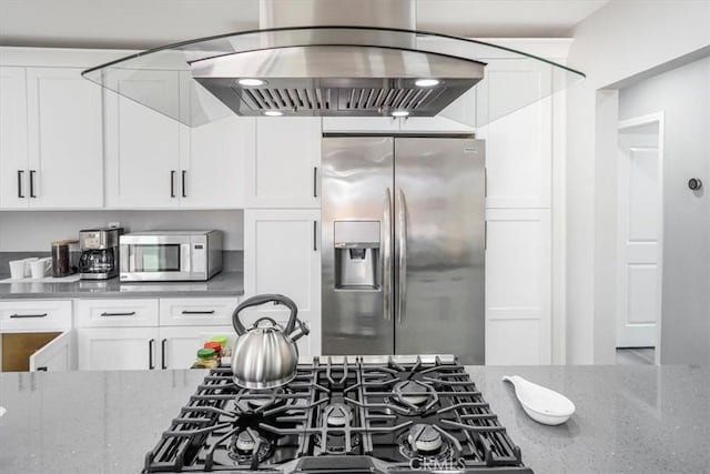 39120 Paradise Way, Cathedral City, CA 92234 - kitchen featuring light stone counters, stainless steel fridge, white cabinets, and island exhaust hood
