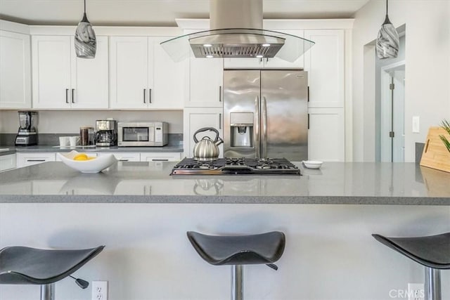 39120 Paradise Way, Cathedral City, CA 92234 - kitchen featuring hanging light fixtures, stainless steel appliances, a kitchen breakfast bar, and white cabinets