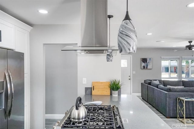 39120 Paradise Way, Cathedral City, CA 92234 - kitchen with white cabinetry, a healthy amount of sunlight, ceiling fan, and stainless steel fridge with ice dispenser