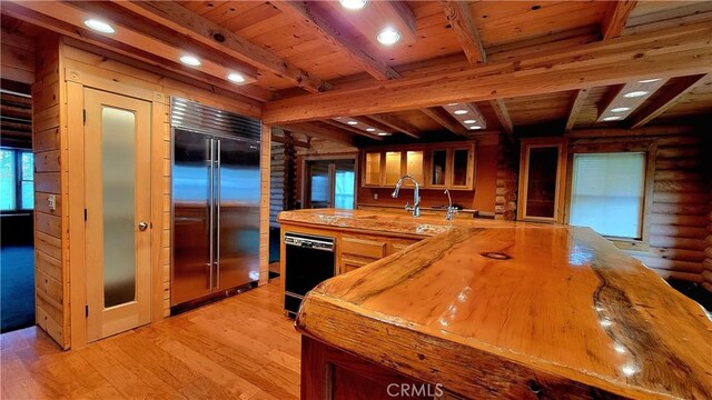 kitchen featuring sink, wooden ceiling, light hardwood / wood-style floors, and stainless steel built in refrigerator