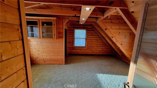 additional living space with wood ceiling, log walls, and vaulted ceiling with beams