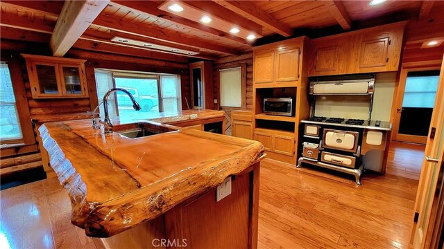 kitchen featuring light hardwood / wood-style floors, sink, and wooden ceiling