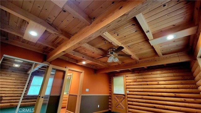 additional living space with beam ceiling, wood ceiling, and ceiling fan