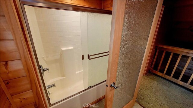 bathroom with shower / bath combination with glass door