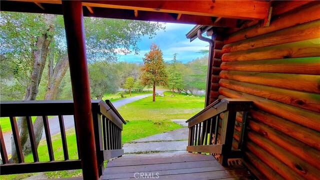 wooden deck with a lawn