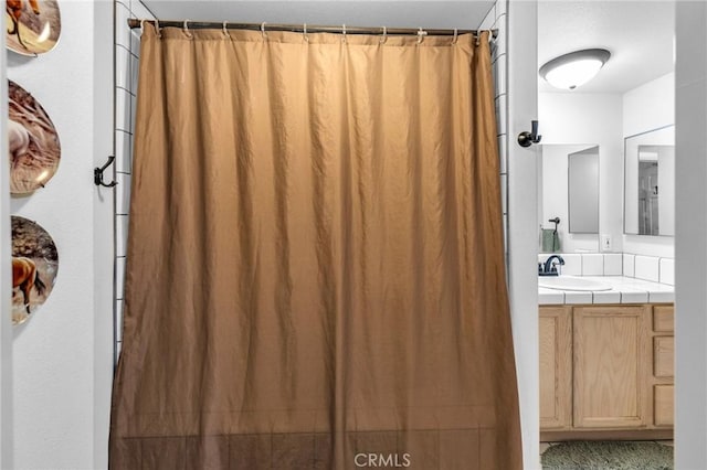 bathroom with vanity and a shower with shower curtain
