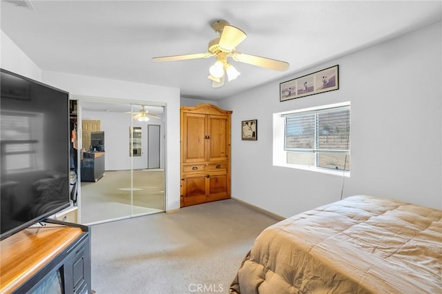 carpeted bedroom with a closet and ceiling fan