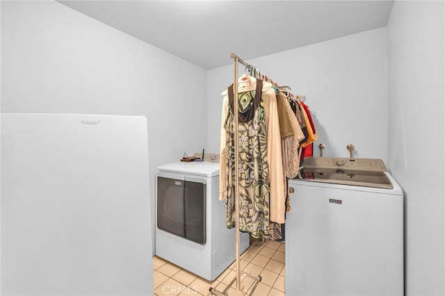 laundry room with light tile patterned floors and washer and dryer