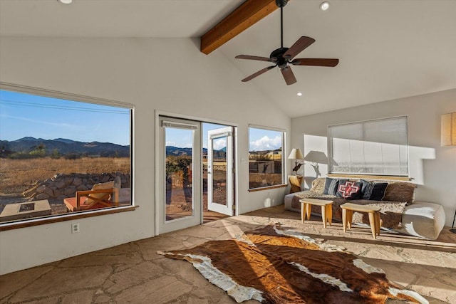 sunroom / solarium with a mountain view, vaulted ceiling with beams, and ceiling fan