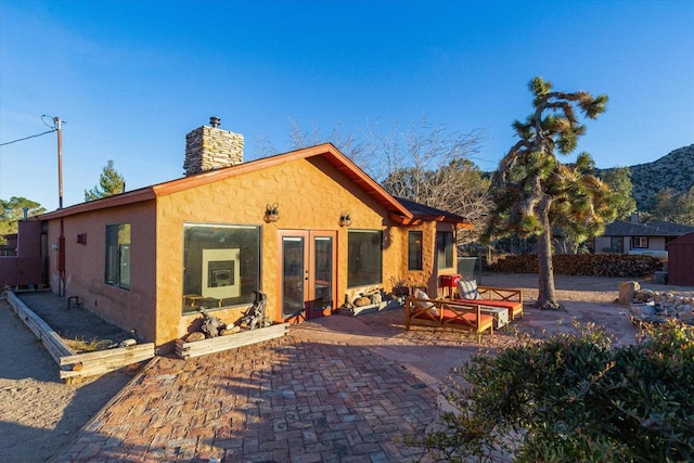 rear view of property featuring a patio and a mountain view