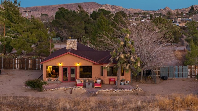 rear view of property with a mountain view, a patio, and french doors