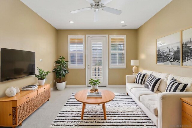 living room with ceiling fan and light carpet