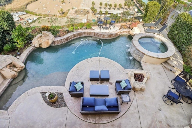 view of swimming pool featuring an in ground hot tub, pool water feature, and a patio area