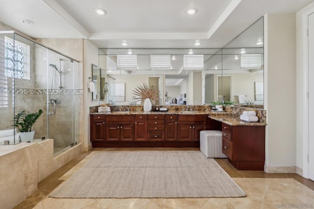 bathroom featuring tile patterned flooring, vanity, and walk in shower