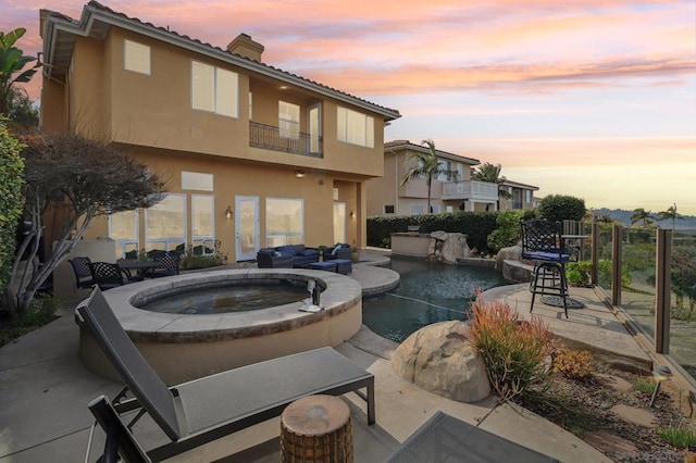 exterior space with a patio area and a pool with hot tub