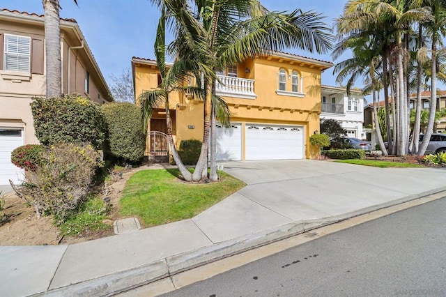 view of front of property featuring a balcony and a garage