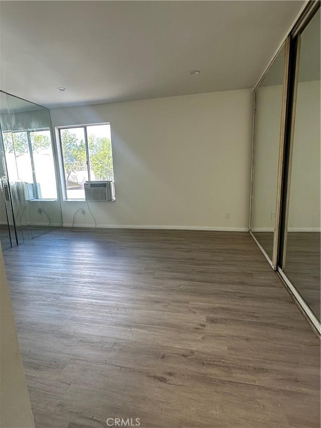 empty room featuring hardwood / wood-style flooring and cooling unit