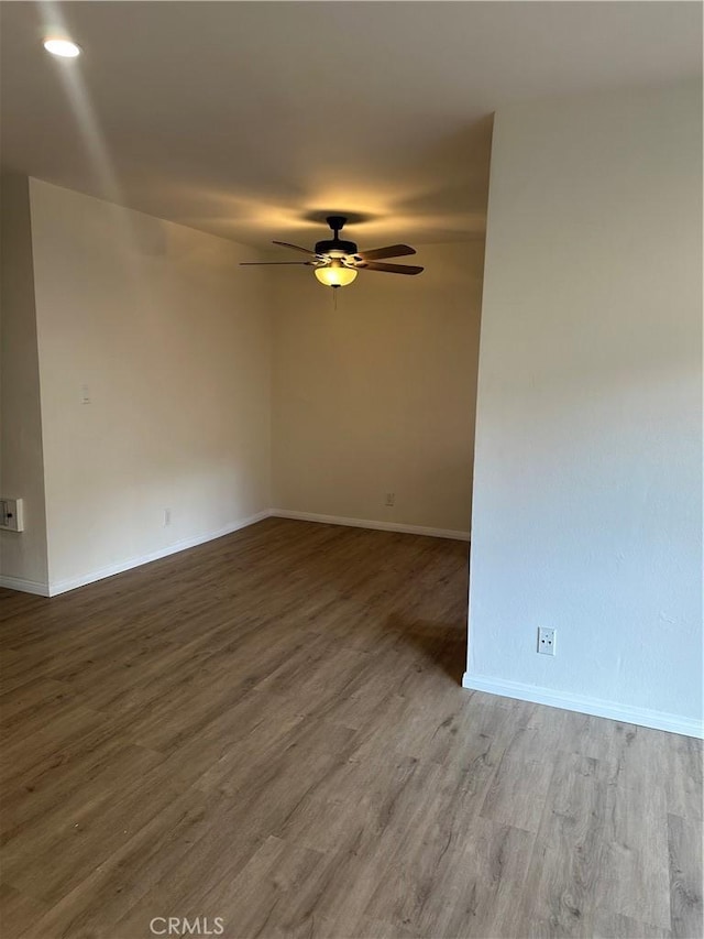 spare room with ceiling fan and hardwood / wood-style floors