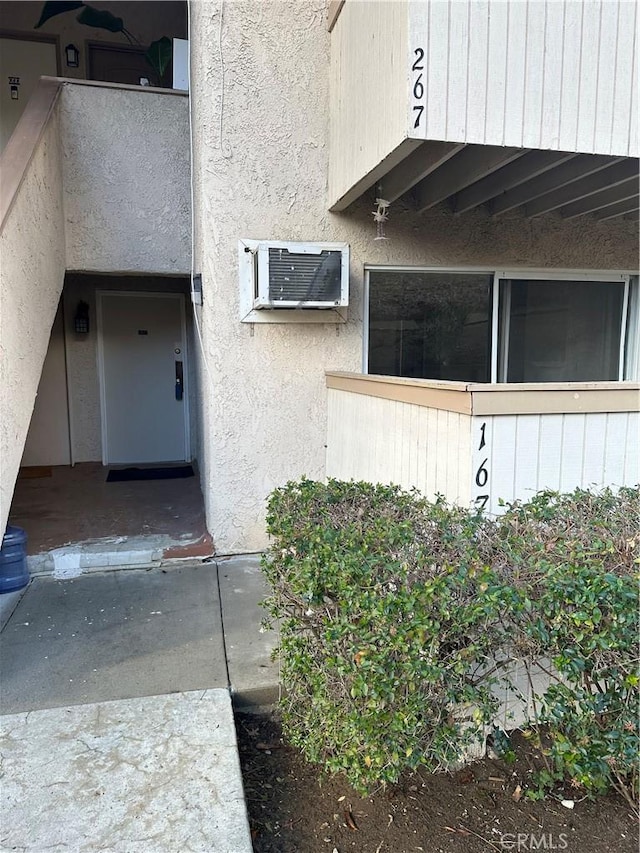 property entrance with an AC wall unit