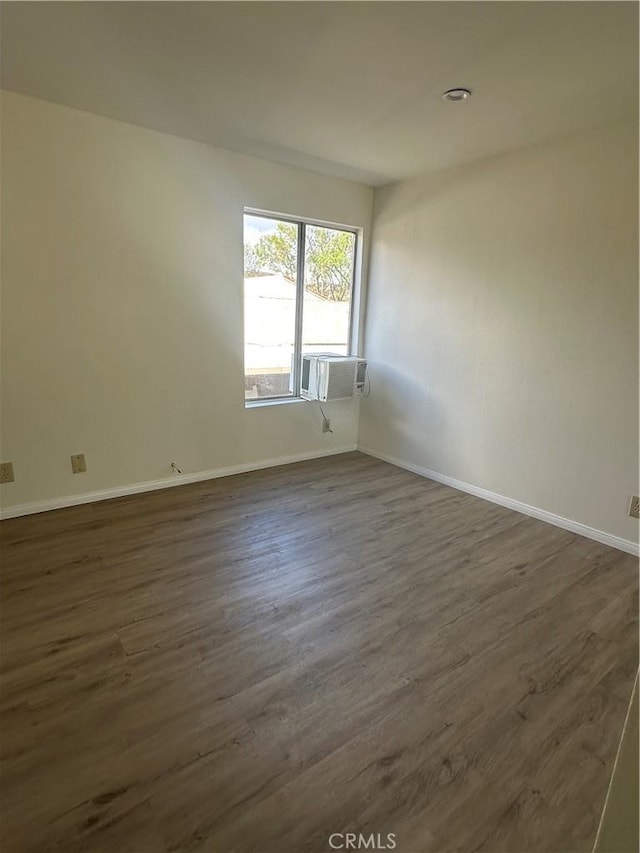 unfurnished room featuring dark hardwood / wood-style floors and cooling unit