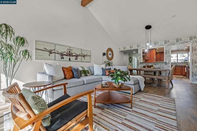 living room featuring wood-type flooring, beam ceiling, and high vaulted ceiling