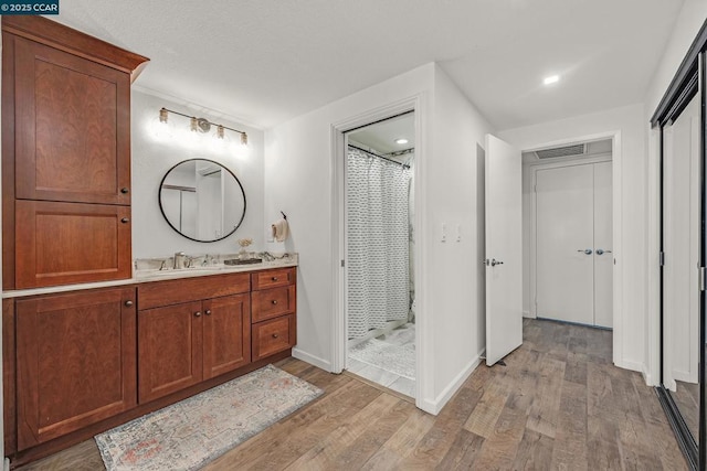 bathroom featuring vanity, hardwood / wood-style flooring, and a shower with shower curtain