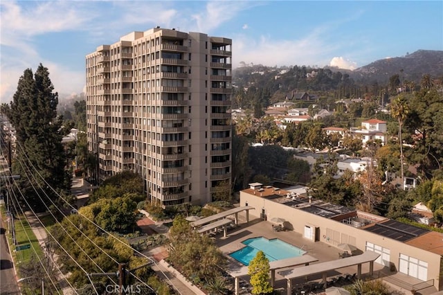 view of building exterior featuring a community pool