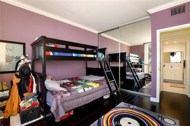 bedroom featuring dark wood-type flooring and ornamental molding