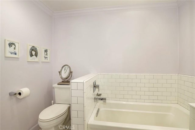 bathroom featuring a tub to relax in, ornamental molding, and toilet