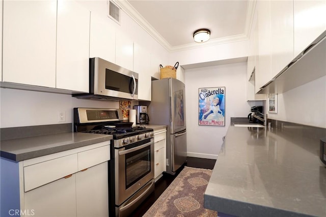 kitchen featuring white cabinetry, ornamental molding, appliances with stainless steel finishes, and sink