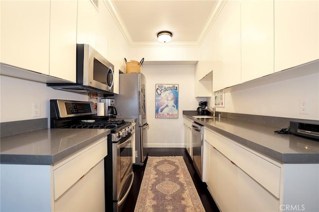 kitchen with ornamental molding, appliances with stainless steel finishes, sink, and white cabinets