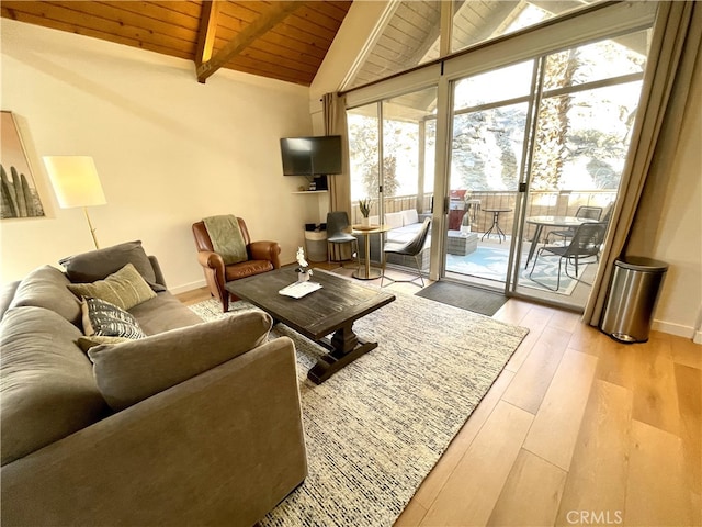 living room featuring wood ceiling, light hardwood / wood-style floors, and lofted ceiling with beams