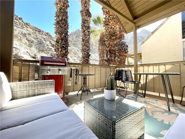 balcony with area for grilling, a mountain view, and outdoor lounge area