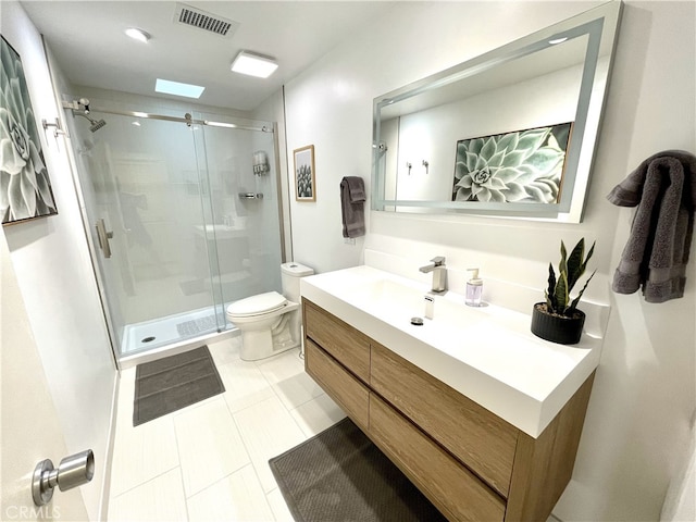 bathroom featuring vanity, an enclosed shower, tile patterned floors, and toilet