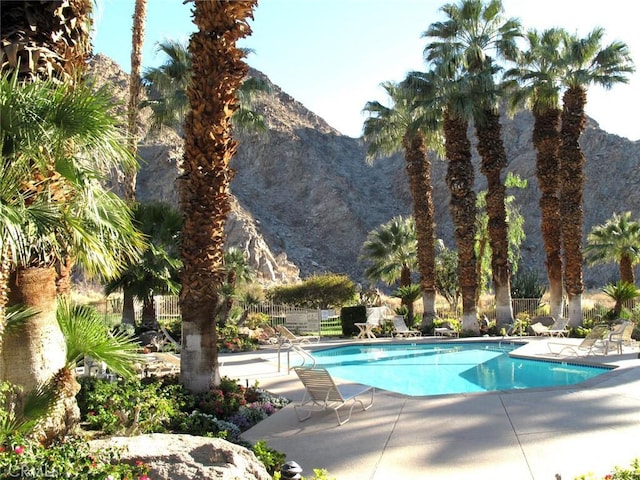 view of swimming pool featuring a mountain view and a patio area