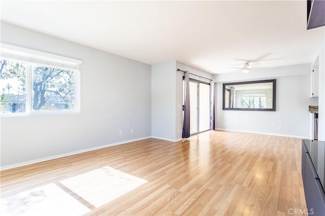 unfurnished living room featuring ceiling fan and light wood-type flooring