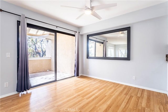 spare room featuring light hardwood / wood-style flooring, a wealth of natural light, and ceiling fan